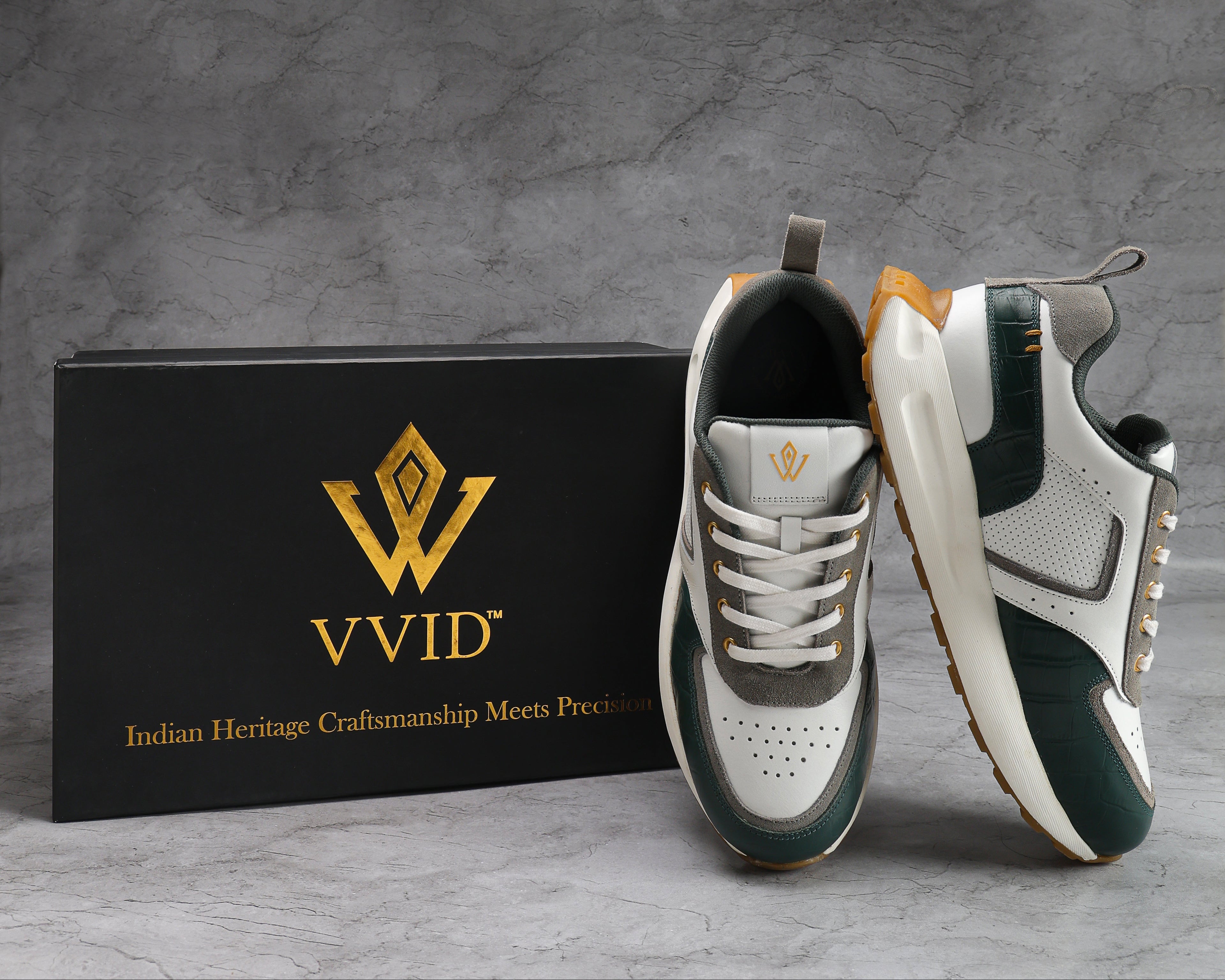 Pair of white and green VVID_Croro_Leather _Snakers with a black box featuring 'VVID' logo on a gray background