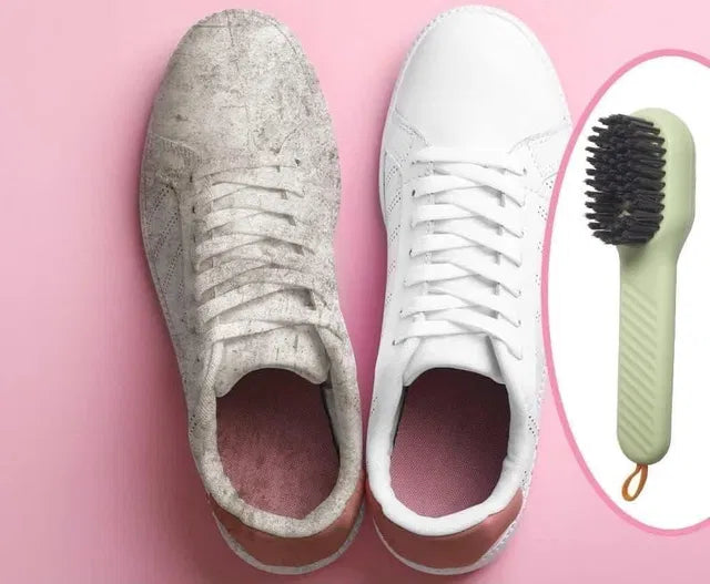 Pair of dirty sneakers next to a white sneaker and a brush on a pink background