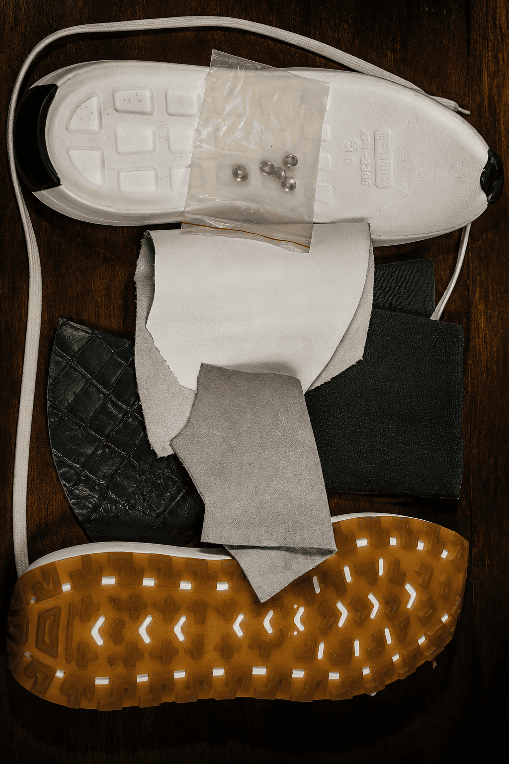 Close-up of a shoe with various materials and tools on a wooden surface