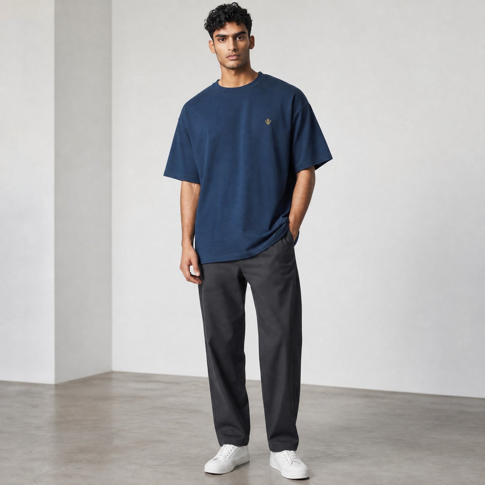 VVID Essential Oversized Tee in deep blue, featuring a small gold embroidered logo on the chest. Made from premium cotton.