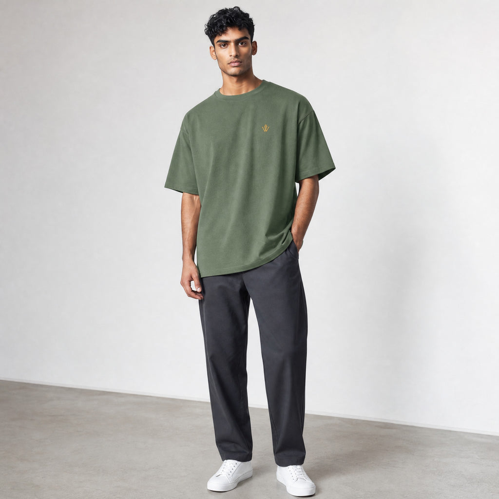 VVID Essential Oversized Tee in olive green, featuring a small gold embroidered logo on the chest. Made from premium cotton.