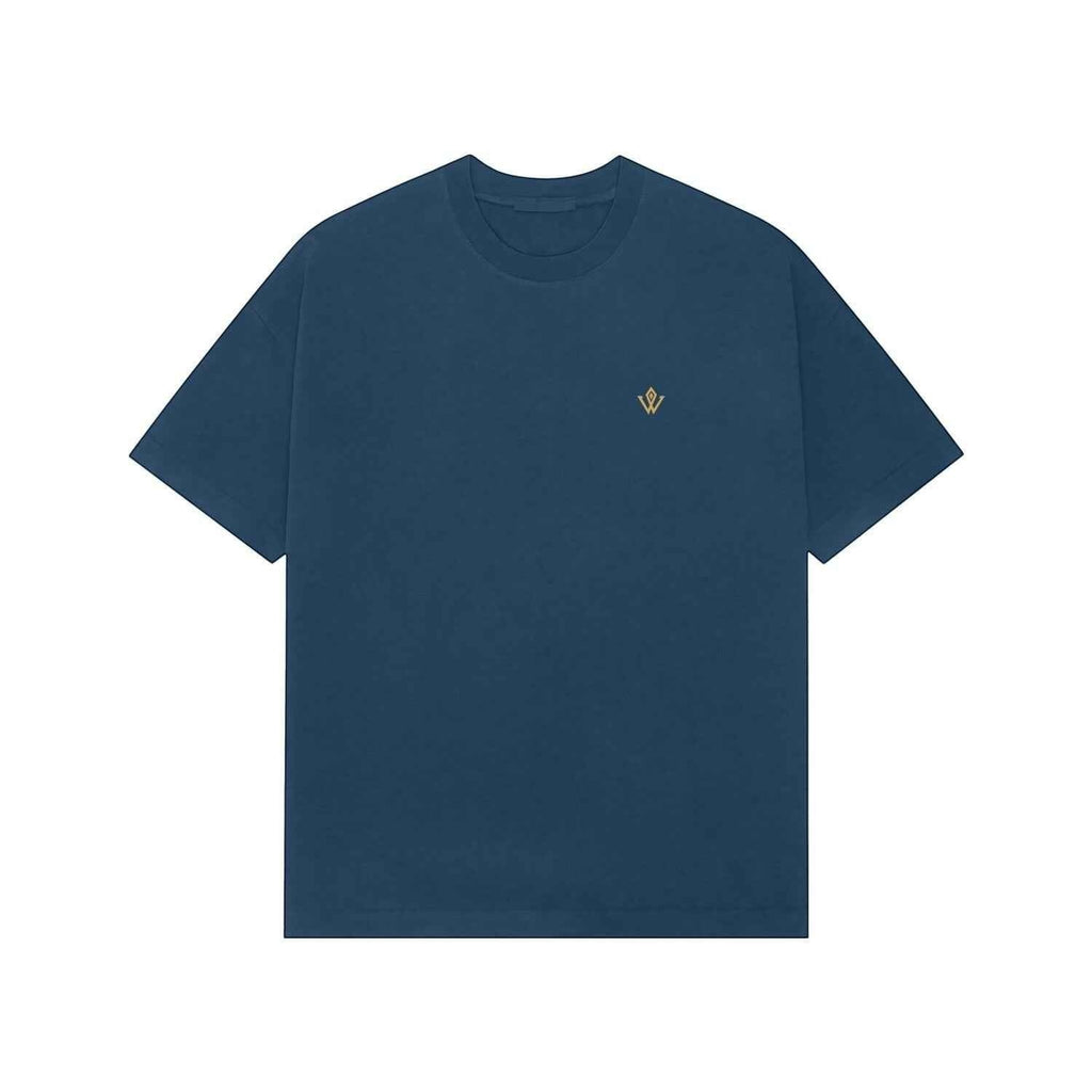 VVID Essential Oversized Tee in deep teal blue, featuring a small gold embroidered logo on the chest. Made from premium cotton for a relaxed fit.